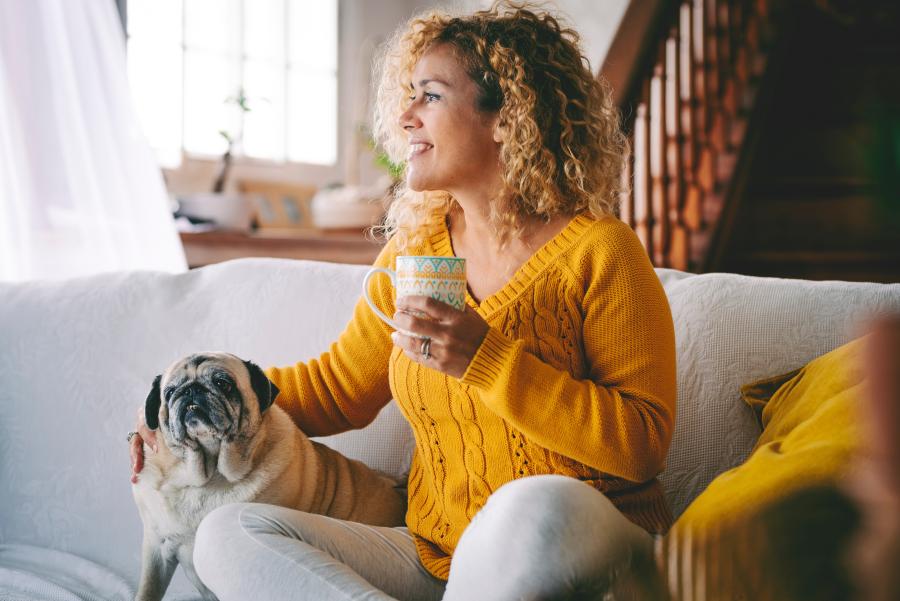 Woman relaxing at home with her pet after resolving a rental dispute